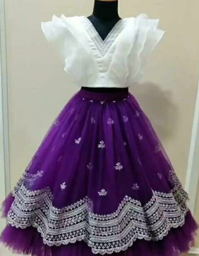 white blouse and purple floral skirt.